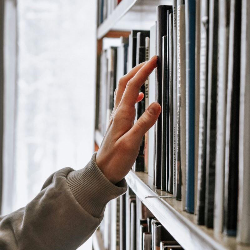 Student grabbing book